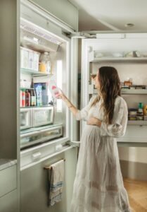 woman-reaching-into-fridge-865x1243.jpg