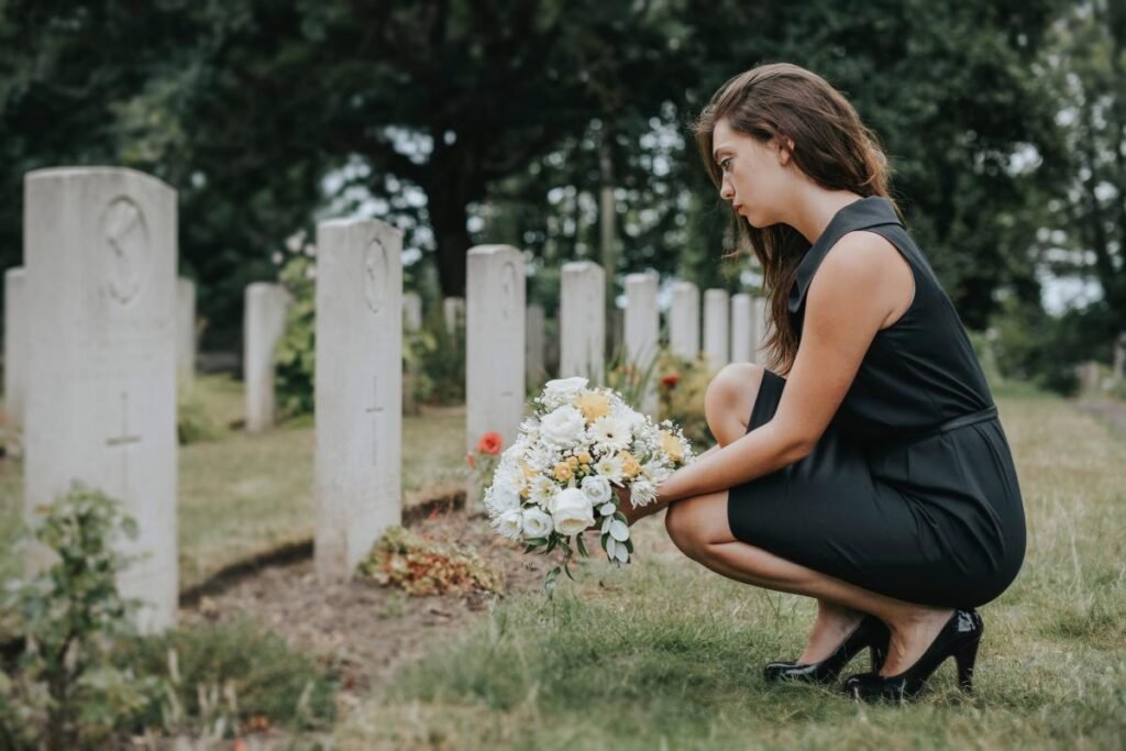 young-widow-laying-flowers-grave-135278284.jpg