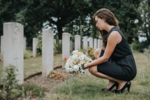 young-widow-laying-flowers-grave-135278284.jpg
